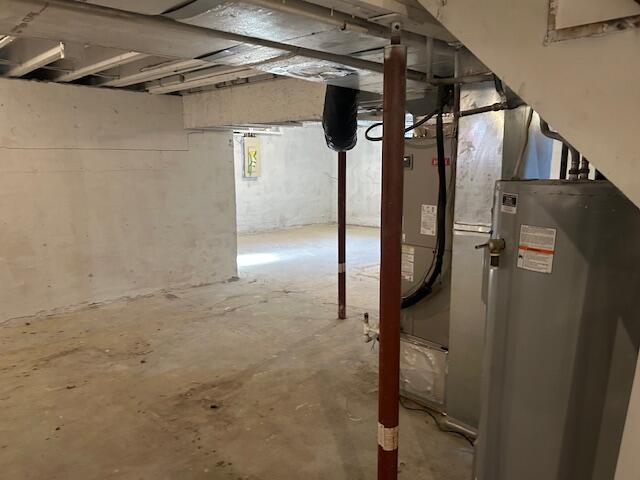 unfinished basement featuring gas water heater