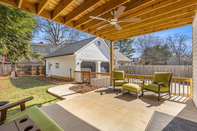 view of patio with ceiling fan, an outbuilding, and a fenced backyard