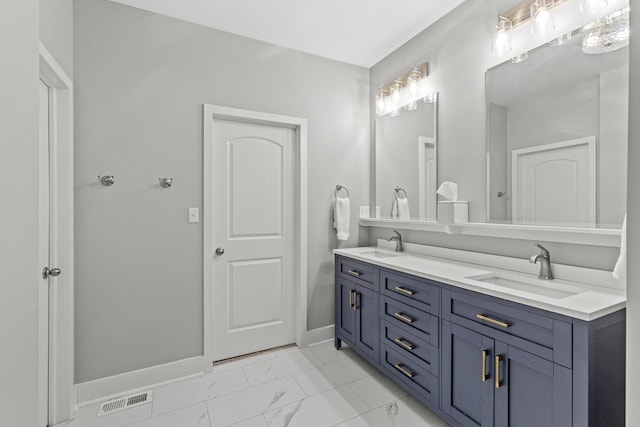 full bath featuring a sink, visible vents, baseboards, and marble finish floor