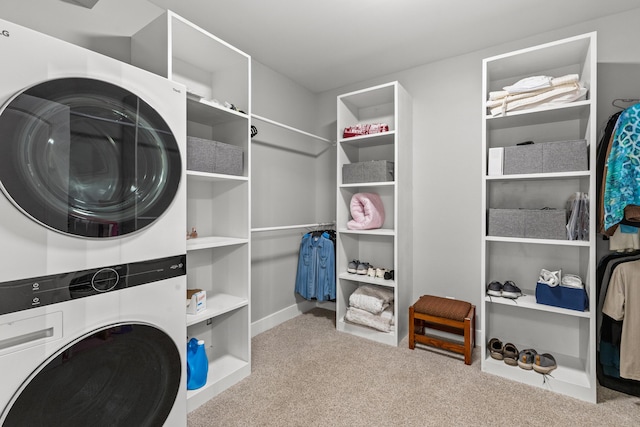 washroom featuring stacked washer / dryer, laundry area, and carpet floors