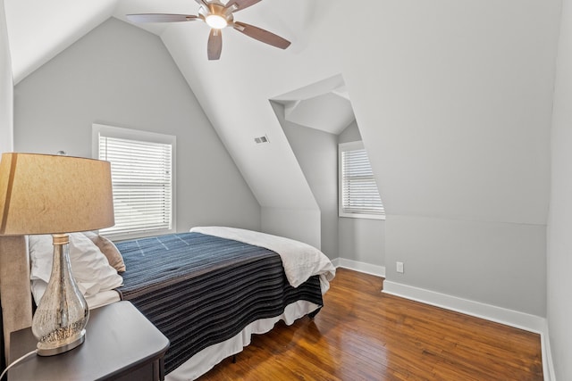 bedroom featuring multiple windows, wood finished floors, visible vents, and baseboards