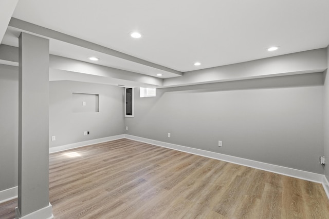 finished below grade area with recessed lighting, baseboards, and light wood finished floors