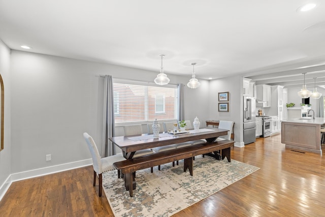 dining area with recessed lighting, baseboards, and light wood-style flooring