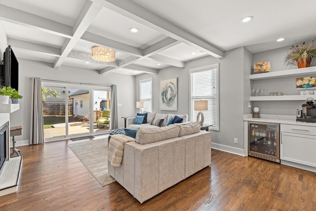 living area featuring baseboards, a fireplace, dark wood-style flooring, a bar, and wine cooler