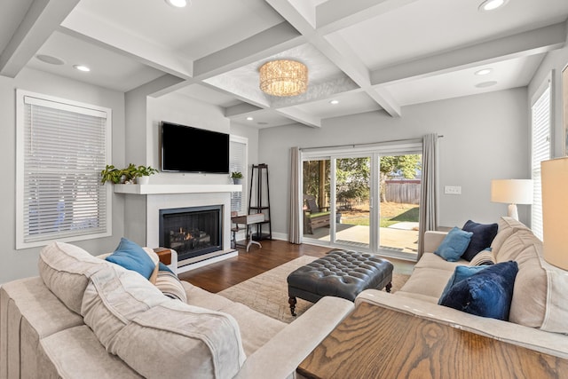 living room with beamed ceiling, coffered ceiling, wood finished floors, recessed lighting, and a lit fireplace