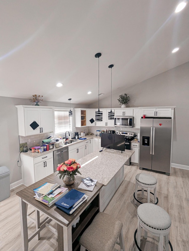 interior space featuring recessed lighting, baseboards, light wood-style floors, and vaulted ceiling