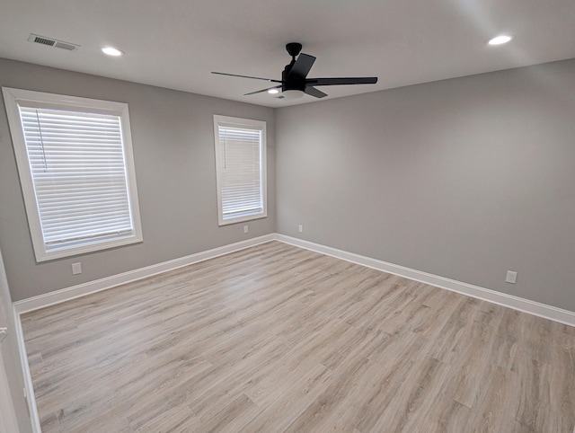 unfurnished room with visible vents, baseboards, a ceiling fan, and light wood finished floors