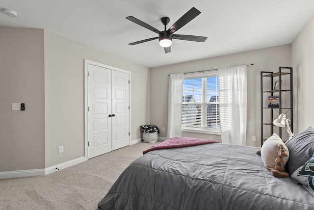 carpeted bedroom featuring baseboards, a closet, and ceiling fan