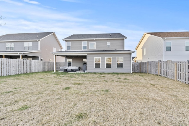 rear view of house featuring an outdoor living space, a yard, a fenced backyard, and a patio