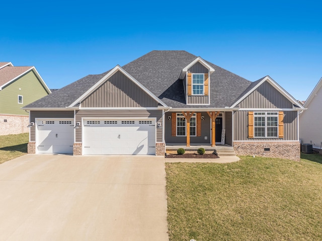 craftsman-style house featuring a shingled roof, covered porch, concrete driveway, an attached garage, and a front yard