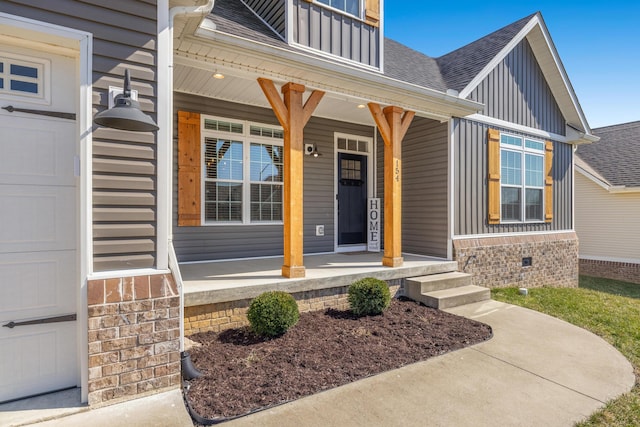 entrance to property with a garage, a porch, board and batten siding, roof with shingles, and crawl space