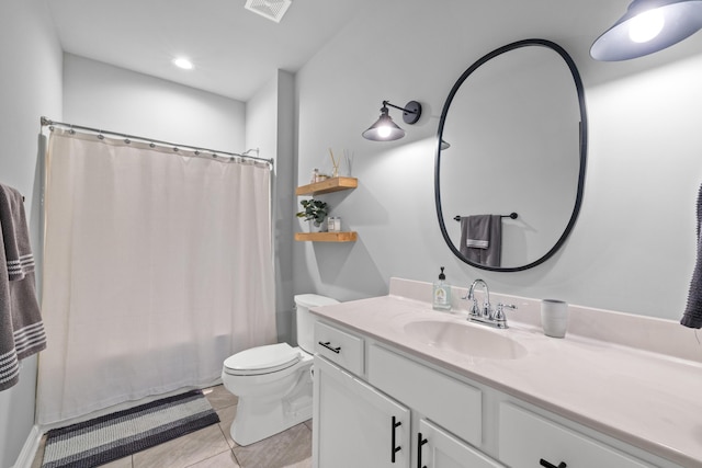 full bath with vanity, a shower with shower curtain, visible vents, tile patterned floors, and toilet