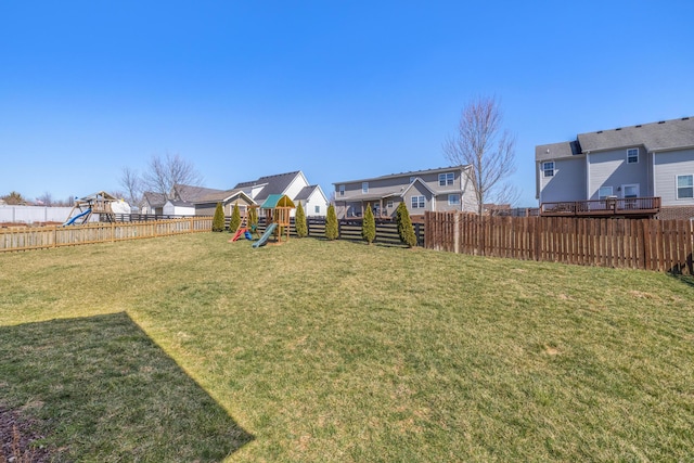 view of yard with a playground and a fenced backyard