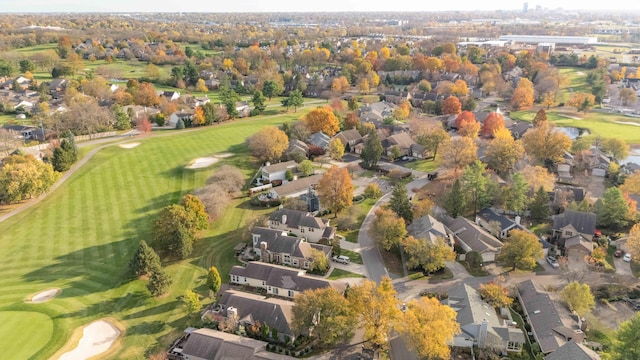 drone / aerial view featuring view of golf course and a residential view