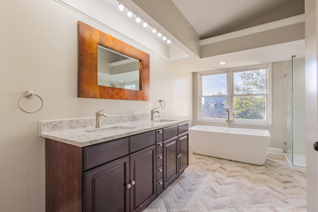 bathroom featuring a sink, a shower stall, double vanity, and vaulted ceiling