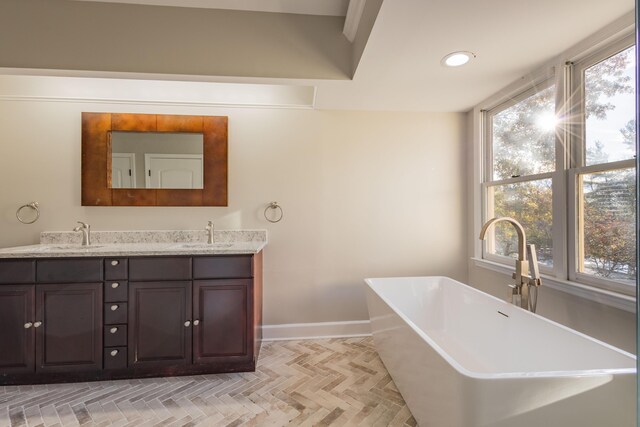 staircase with a high ceiling, baseboards, and wood finished floors