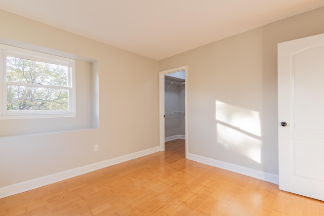 unfurnished room featuring baseboards and light wood-type flooring