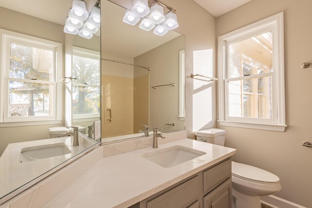 full bathroom featuring a sink, lofted ceiling, a stall shower, and double vanity