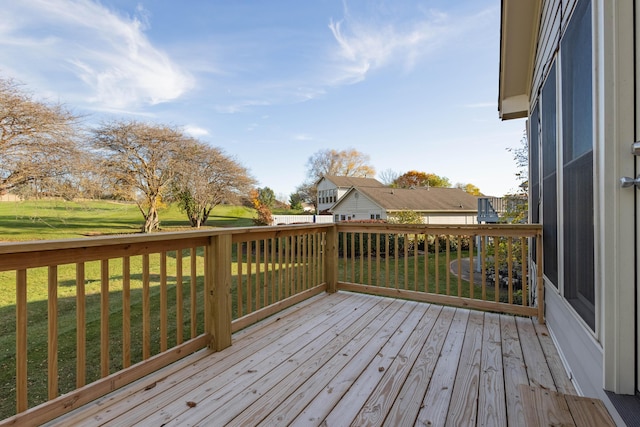 wooden terrace featuring a lawn