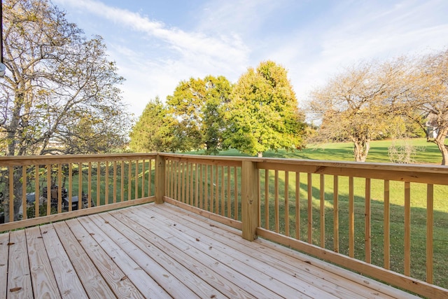 wooden terrace with a lawn