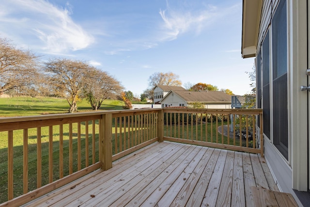 wooden deck featuring a lawn