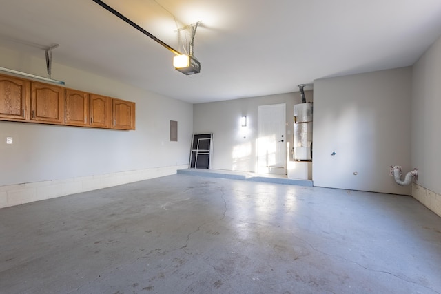 garage featuring electric panel, a garage door opener, and water heater