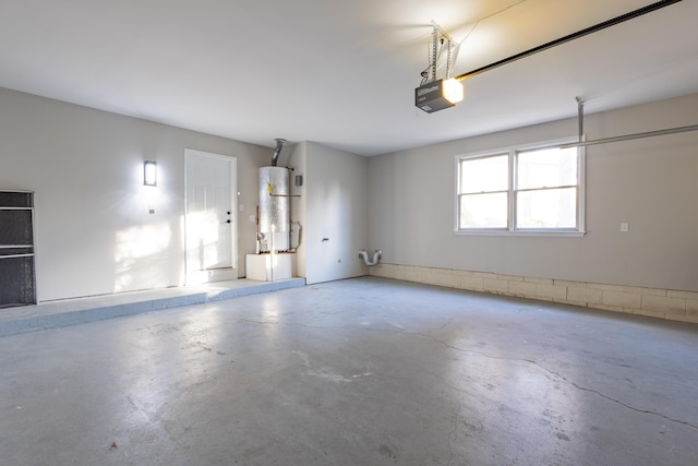 garage with a garage door opener and water heater