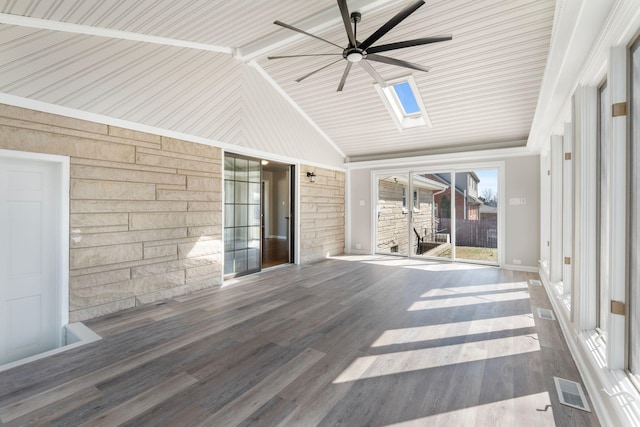 unfurnished sunroom featuring visible vents, vaulted ceiling with skylight, and ceiling fan