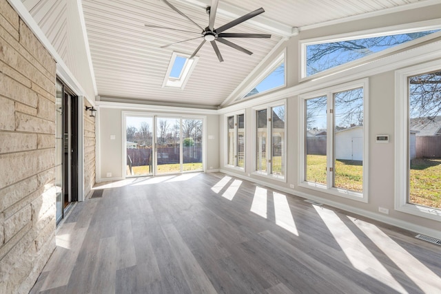 unfurnished sunroom featuring visible vents, vaulted ceiling with skylight, and a ceiling fan