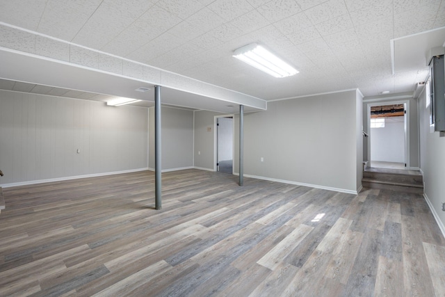 below grade area with baseboards and wood finished floors