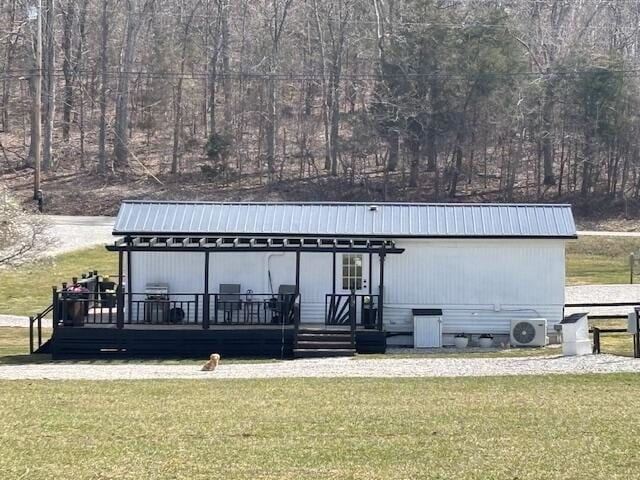 view of dock featuring a lawn and ac unit