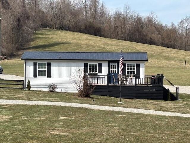 view of front of house featuring a front yard and a wooden deck