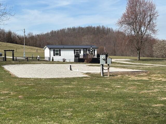 view of property's community with a yard and a wooded view