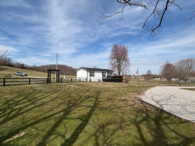 view of yard with an outdoor structure and fence