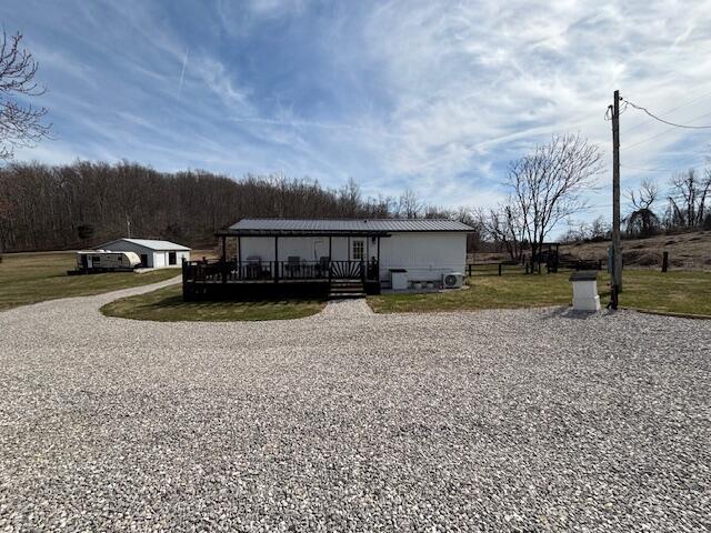 manufactured / mobile home featuring a front yard and a deck