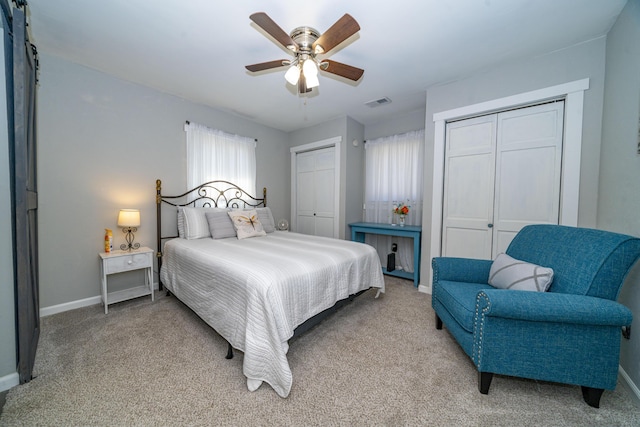 285 Hill Rd, Somerset, KY 42501 - bedroom with baseboards, visible vents, ceiling fan, light carpet, and two closets