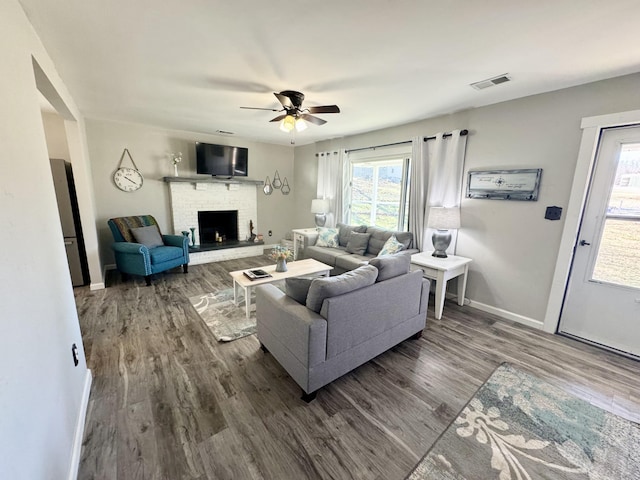 285 Hill Rd, Somerset, KY 42501 - living room featuring a ceiling fan, wood finished floors, visible vents, baseboards, and a brick fireplace