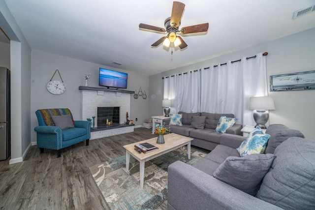 285 Hill Rd, Somerset, KY 42501 - living room featuring visible vents, a brick fireplace, ceiling fan, baseboards, and wood finished floors