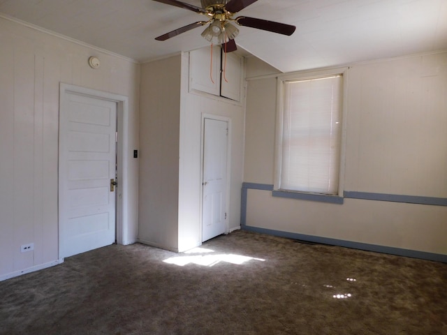 unfurnished room with a ceiling fan, crown molding, carpet, and baseboards