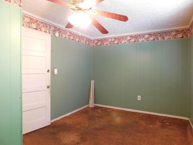 carpeted spare room with baseboards, a textured ceiling, crown molding, and ceiling fan