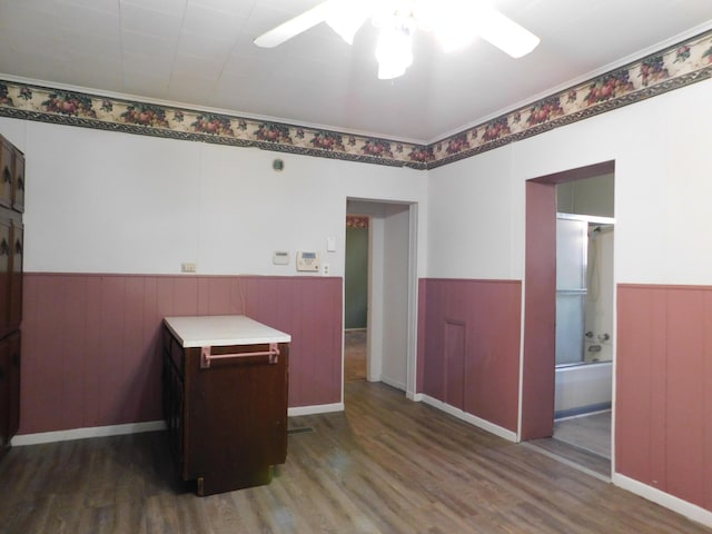 spare room with a wainscoted wall and wood finished floors