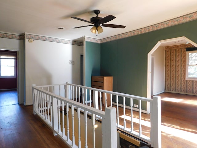 hallway with an upstairs landing, wood finished floors, and visible vents