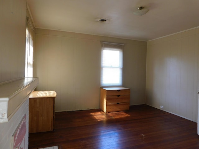 interior space with visible vents, crown molding, and dark wood-type flooring