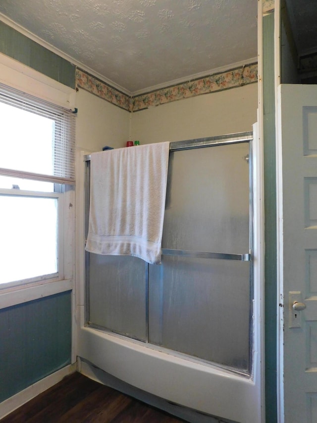 bathroom with a textured ceiling and wood finished floors