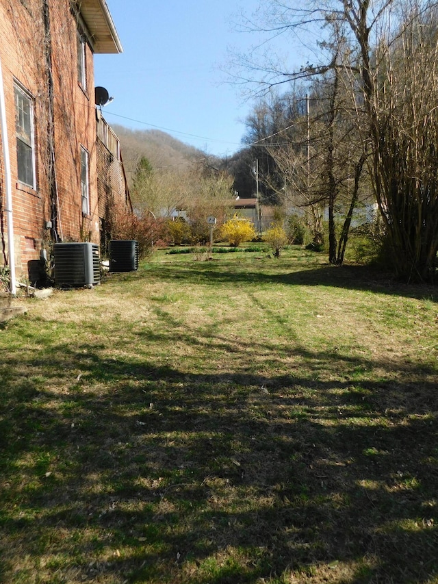 view of yard with central air condition unit