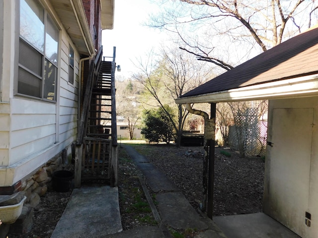 view of side of home with stairs