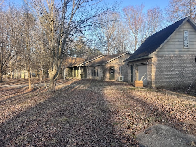 view of home's exterior with a garage and brick siding