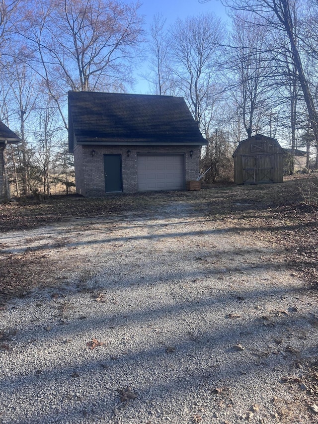 exterior space featuring driveway and a storage shed