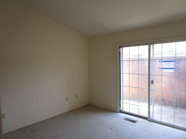 unfurnished room featuring visible vents and light colored carpet