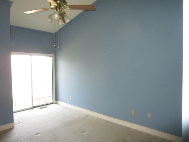 unfurnished room with visible vents, baseboards, vaulted ceiling, carpet flooring, and a ceiling fan